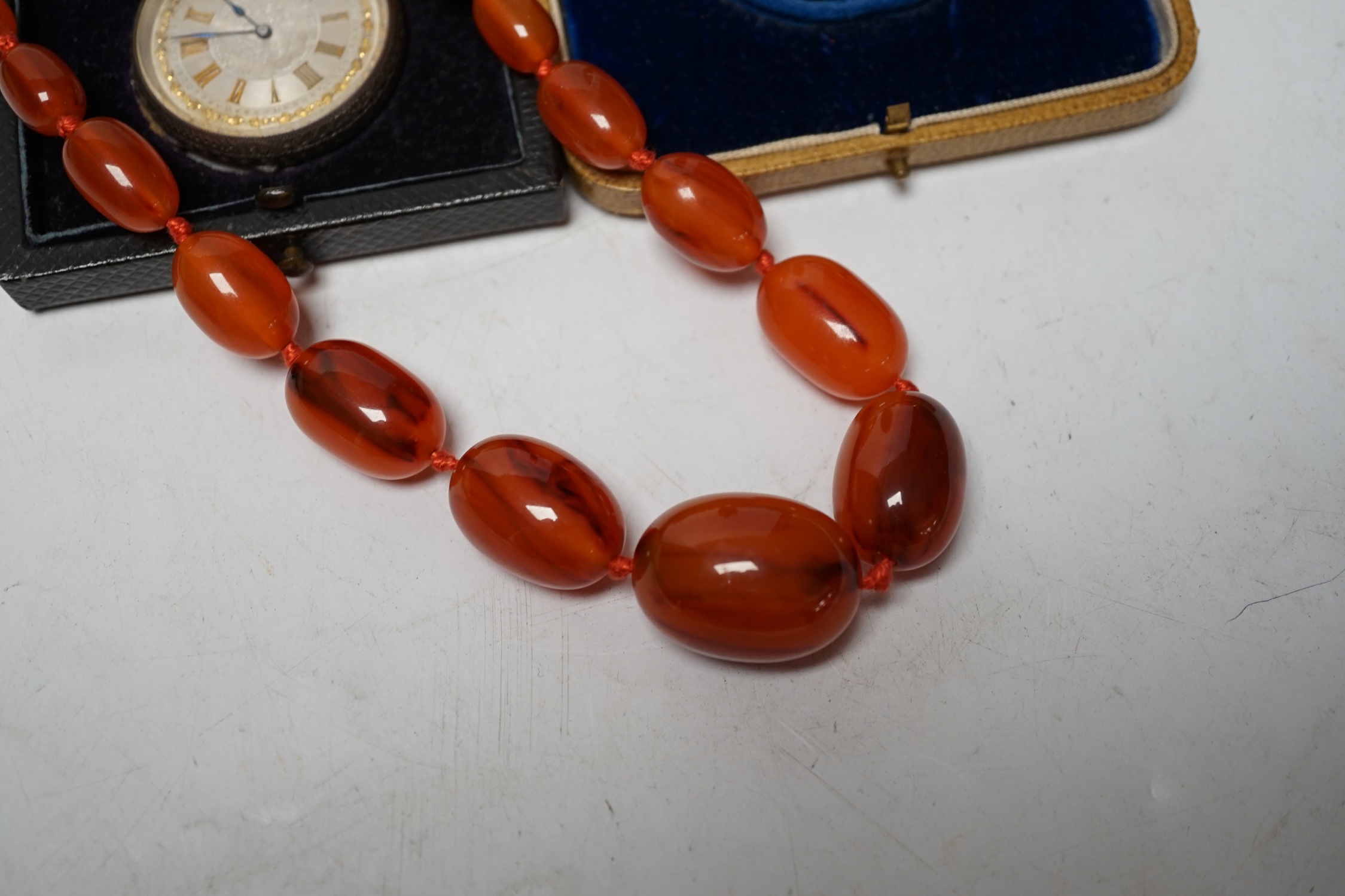 A Swiss 935 white metal fob watch, a gold played Waltham hunter pocket watch and a string of simulated amber beads. Condition - poor to fair